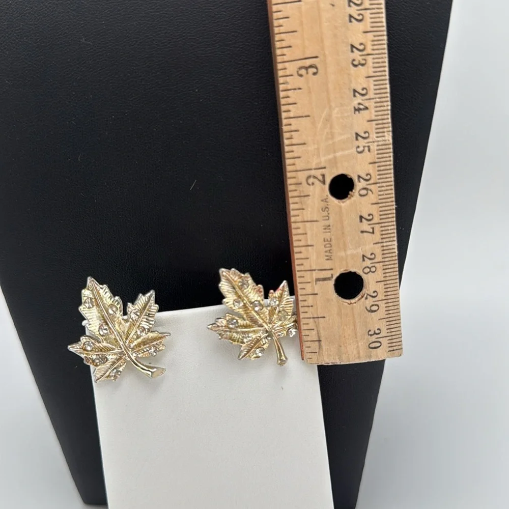Gold tone textured leaf rhinestone accent screw back statement earrings